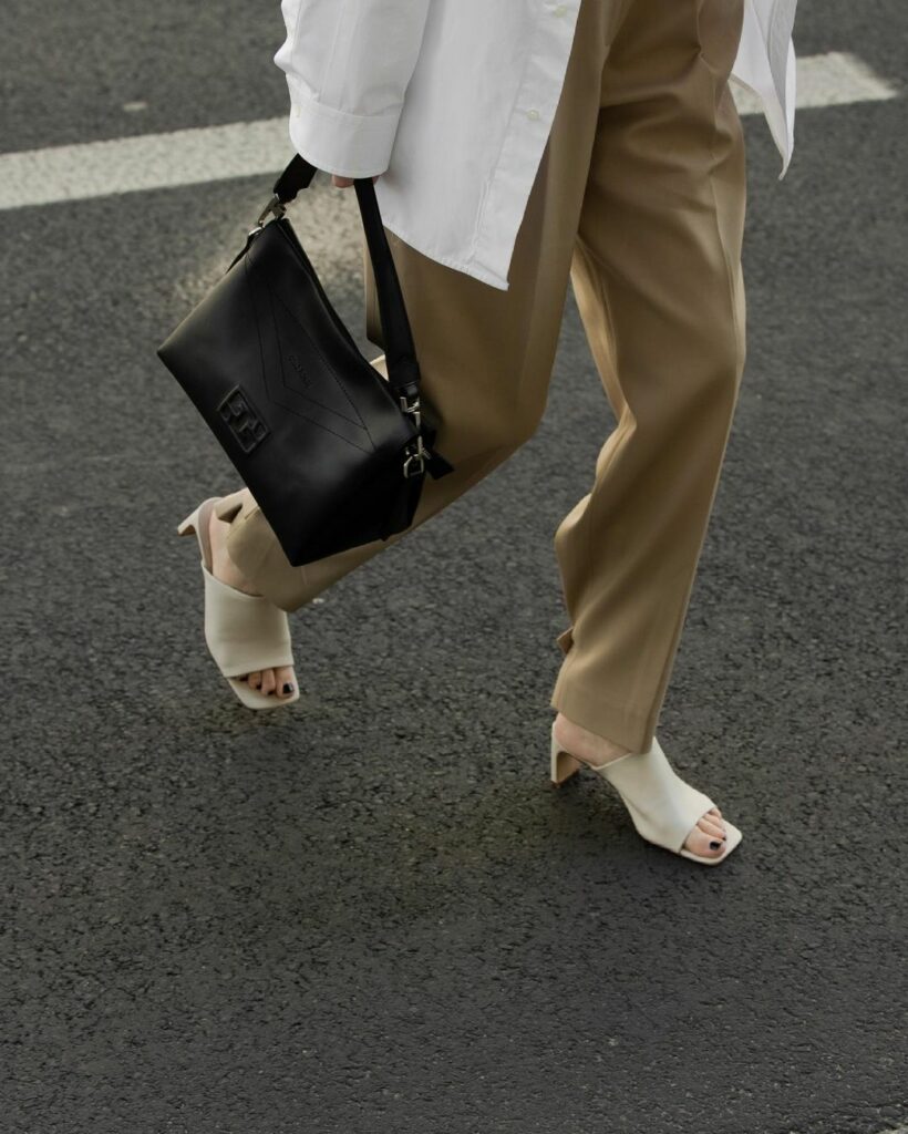 beżowe damskie sandały i czarna torebka w stylu smart casual
